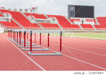 hurdles on the red running track hurdles on the red running track 12497064