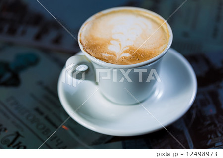 Cup of coffee on a wooden table 12498973