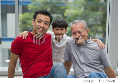 three generation asian men enjoying family bonding time together 12499226