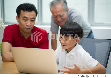 three generation asian men enjoying family bonding time together 12499246