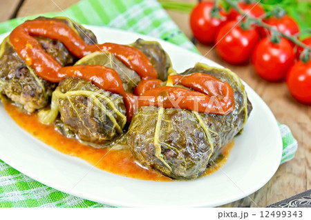 Rhubarb leaves stuffed in plate with sauce on board 12499343