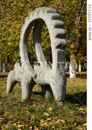 Stone statue featuring a wether with big horns- in the park of Astana, Kazakhstan 12507113