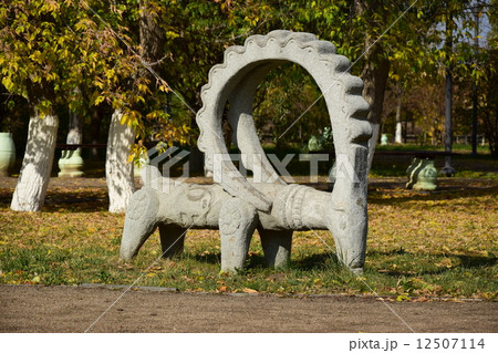 Stone statue featuring a wether with big horns- in the park of Astana, Kazakhstan 12507114
