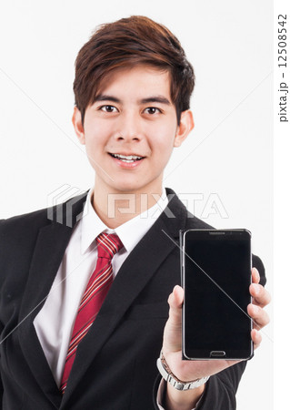 Business executive showing smart phone screen. 12508542