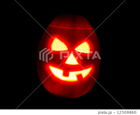 Halloween pumpkin jack-o-lantern candle lit, isolated on black 12509860