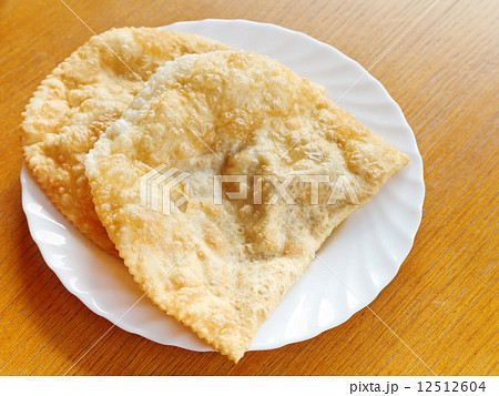 cheburek pie on white plate cheburek pie on white plate 12512604