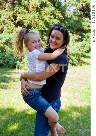 Mother and daughter playing in summer 12518136