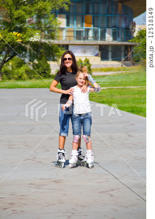 Learning mother and daughter on roller skates Learning mother and daughter on roller skates 12518149