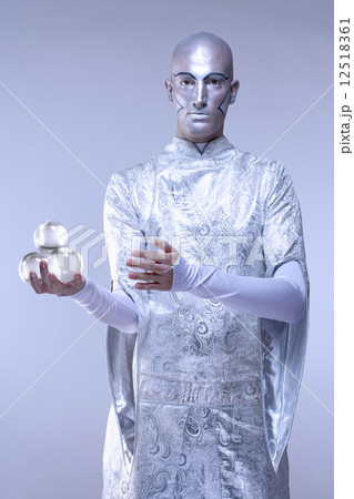 Magician with Glass Balls in Stage Makeup and Costume Magician with Glass Balls in Stage Makeup and Costume 12518361