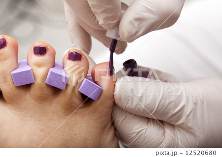 Toenails are painted in fuchsia color 12520680