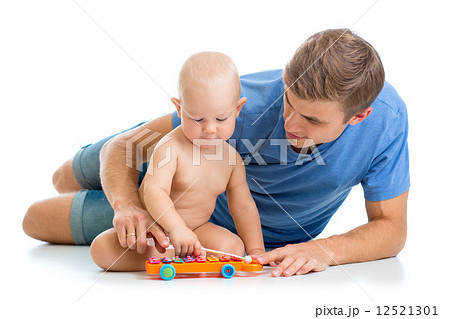 Father and baby boy have fun with musical toys 12521301