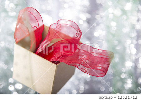 open christmas gift box with red ribbon  in it 12521712