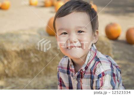Mixed Race Young Boy Having Fun at the Pumpkin Patch 12523334
