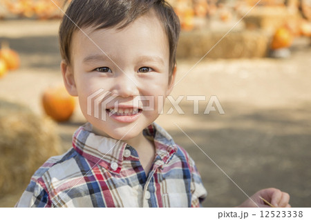 Mixed Race Young Boy Having Fun at the Pumpkin Patch Mixed Race Young Boy Having Fun at the Pumpkin Patch 12523338