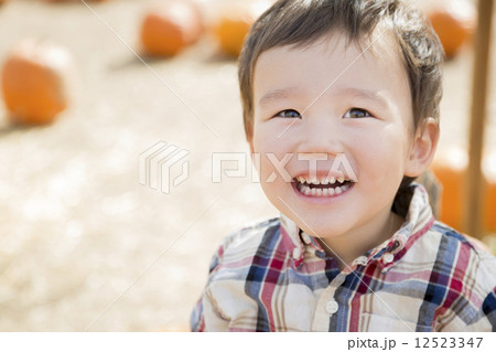 Mixed Race Young Boy Having Fun at the Pumpkin Patch 12523347
