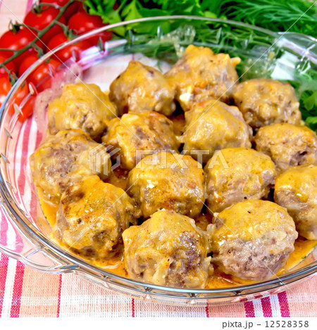 Meatballs with sauce in glass pan on fabric Meatballs with sauce in glass pan on fabric 12528358