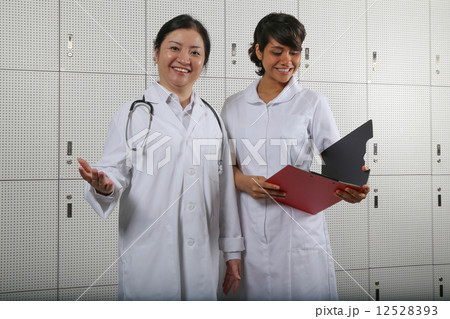 Welcoming lady doctor and enthusiastic nurse team. Welcoming lady doctor and enthusiastic nurse team. 12528393