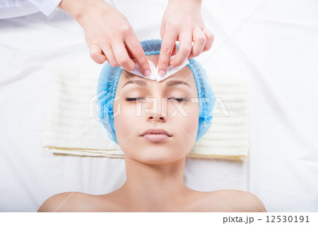 Skin care - woman cleaning face by beautician 12530191