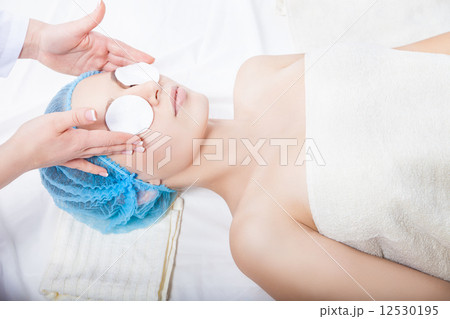 Skin care - woman cleaning face by beautician 12530195