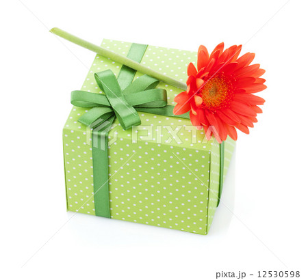 Orange gerbera flower over gift box 12530598
