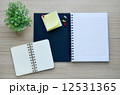 Blank notebook on the wood table - Top view 12531365