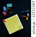 Note pad, Pushpin and Binder clip on black background 12531367