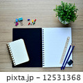 Blank notebook and Pushpin on the wood table - Top view 12531368