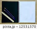 Blank paper, and pencils on the wood table - Top view 12531370