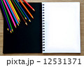 Blank paper and colorful pencils on the wood table - Top view 12531371