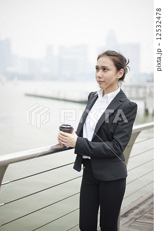 Young Asian executive taking a coffee break. 12532478
