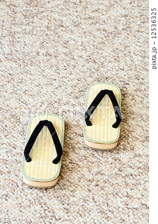 Pair of Traditional Japanese Sandals on Carpet Floor. 12536325