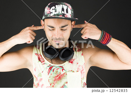 model isolated on plain background plugging ears with fingers 12542835