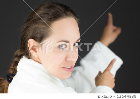 model isolated on plain background looking at camera pointing model isolated on plain background looking at camera pointing 12544839