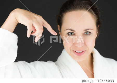 model isolated on plain background pointing to herself 12545033