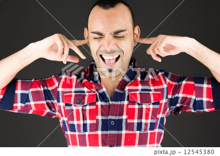 model isolated on plain background plugging ears with fingers model isolated on plain background plugging ears with fingers 12545380
