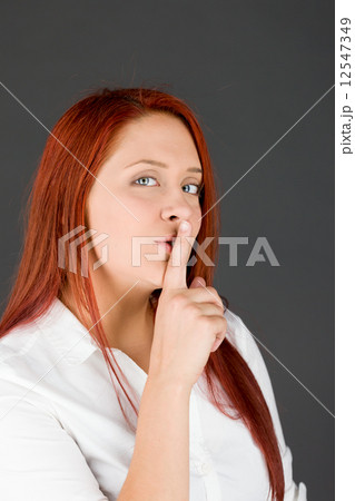 model isolated with finger on lips secret model isolated with finger on lips secret 12547349