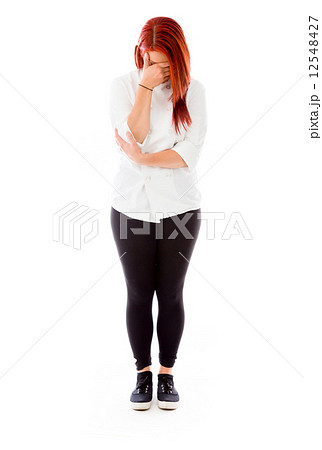model isolated on plain background ashamed hiding face in hand 12548427