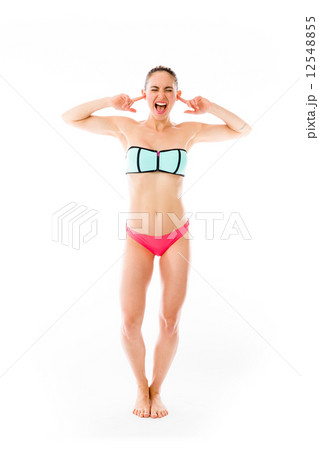 model isolated on plain background plugging ears with fingers 12548855
