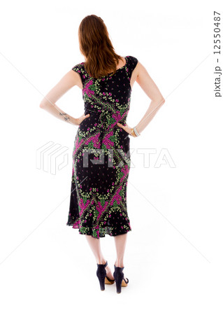 model isolated on plain background back hands on hips 12550487