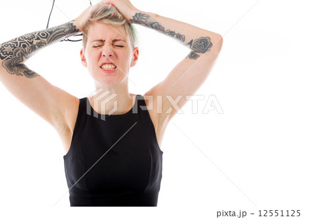 model isolated on plain background stressed upset pulling hairs 12551125