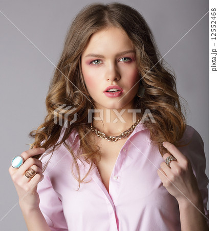 Beauteous Auburn Female in Light Blouse Holding Her Hairs 12552468