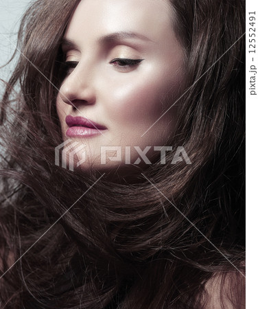 Pretty Woman Brunette with Blowing Healthy Hair 12552491