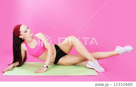 Gymnastics. Abdominal Exercise. Shapely Woman on a Sport Mat Gymnastics. Abdominal Exercise. Shapely Woman on a Sport Mat 12552600