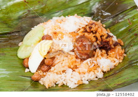 Content of the simple and original traditional banana leaf wrapped nasi lemak. Content of the simple and original traditional banana leaf wrapped nasi lemak. 12558402
