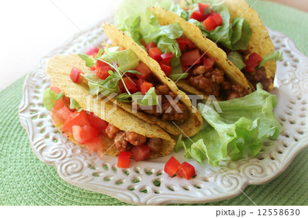 Mexican food - tacos with meat, lettuce and tomatoes  Mexican food - tacos with meat, lettuce and tomatoes  12558630