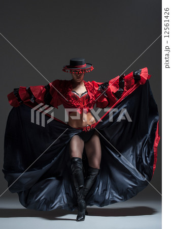 Woman in beautifull red dress dancing in a studio Woman in beautifull red dress dancing in a studio 12561426