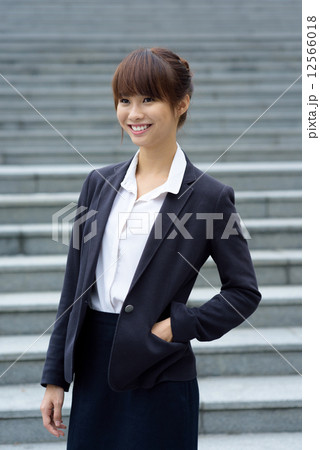 Portrait of one young chinese office lady in front of steps 12566018