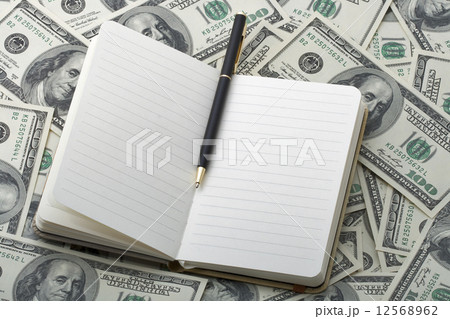 notebook with black pen on 100 dollar banknotes notebook with black pen on 100 dollar banknotes 12568962