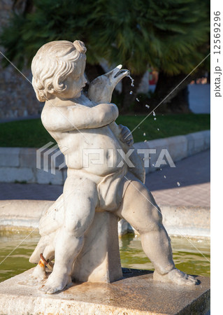 Statue of little boy with goose, street fountain 12569296