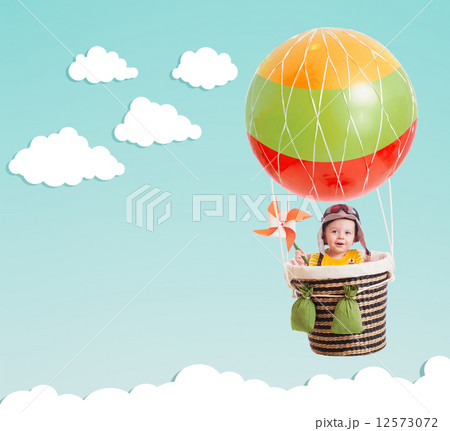 cute kid on hot air balloon in the blue sky cute kid on hot air balloon in the blue sky 12573072